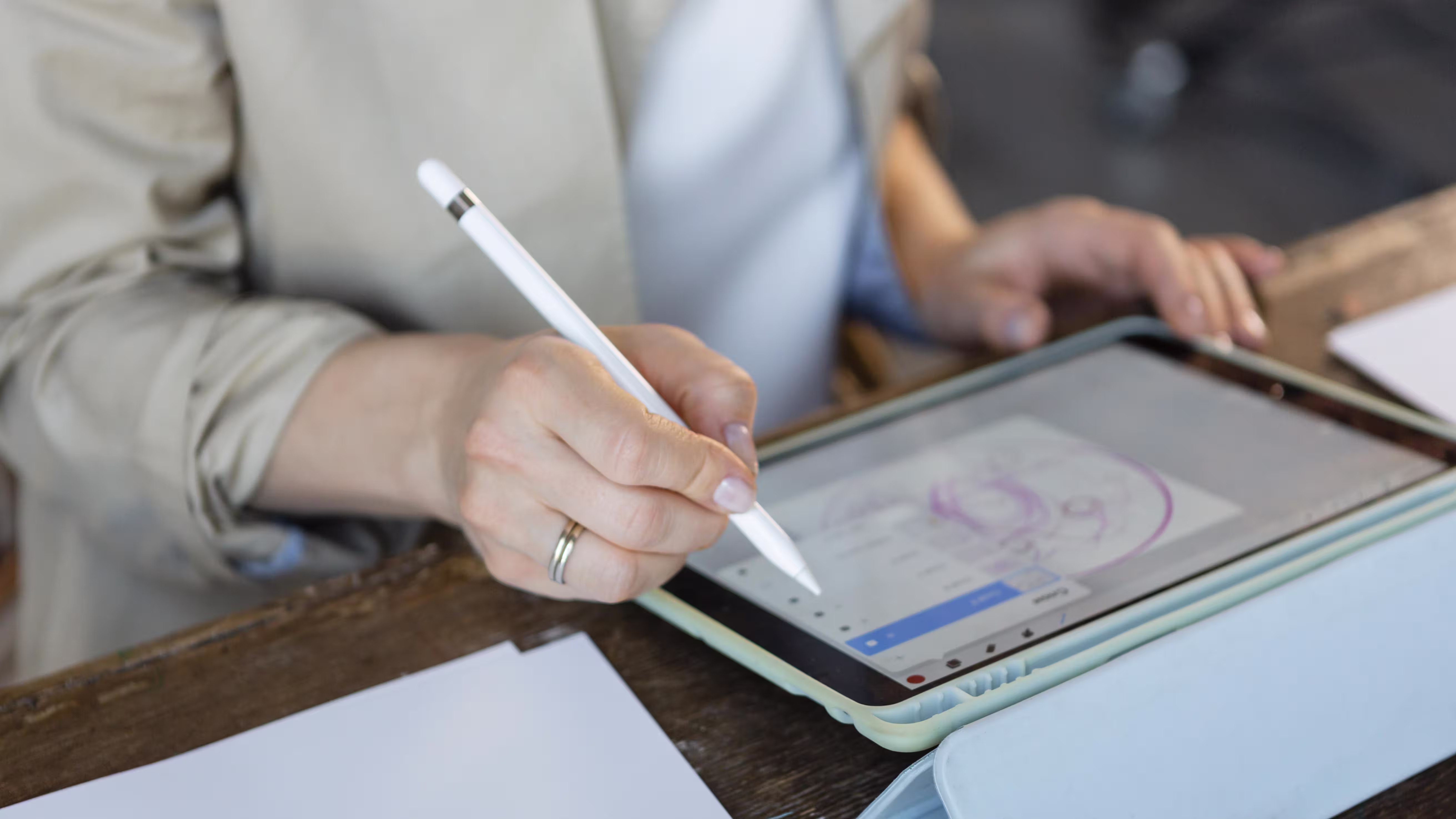 Person using stylus pen to draw with precision and control on tablet screen