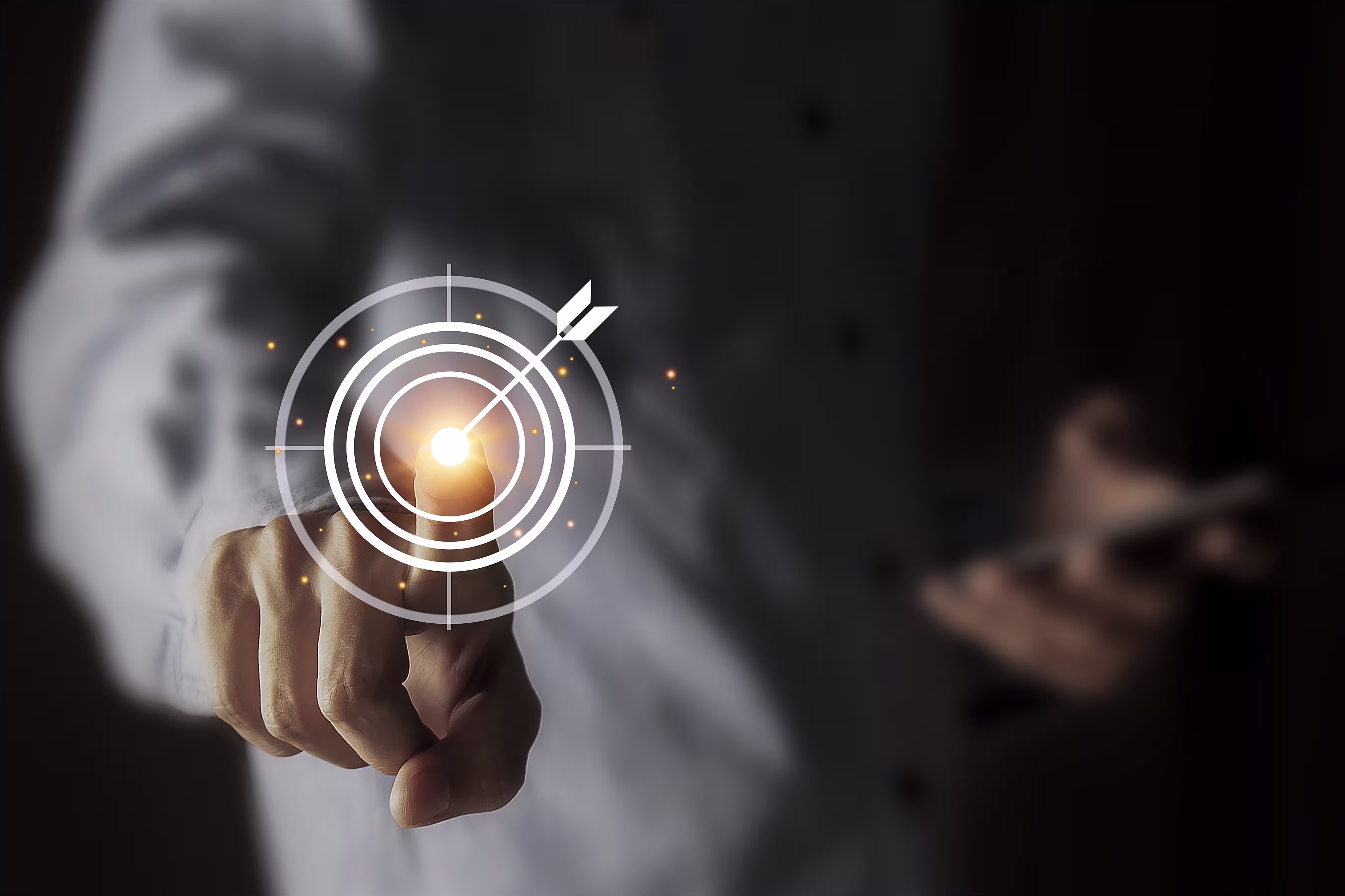 Business professional pointing at a digital target with concentric circles and an arrow hitting the bullseye